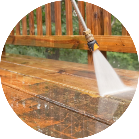 High-pressure water blaster spraying a surface outdoors, used for cleaning