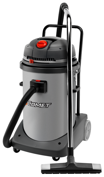 A gray Comet brand vacuum cleaner with a motorized head, being used on a floor.